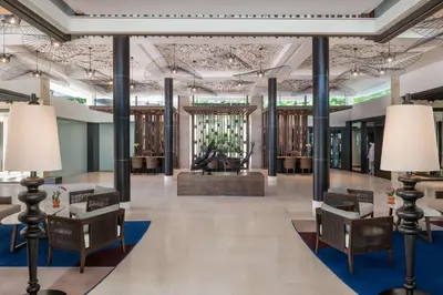 a lobby of a building with chairs and lamps at Hyatt Regency Phuket Resort in Kamala Beach