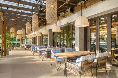 a dining room with tables and chairs and chandeliers at Hyatt Regency Phuket Resort in Kamala Beach