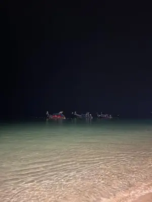 a group of boats in the water at night at Krabi Klong Muang Bay Resort in Klong Muang Beach