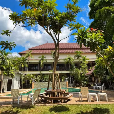 a picnic table and chairs in front of a building at Krabi Klong Muang Bay Resort in Klong Muang Beach