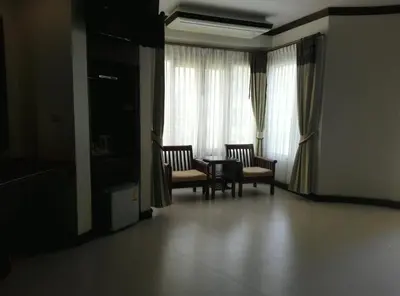 a living room with a table and chairs and a window at Golden Beach Resort in Ao Nang Beach