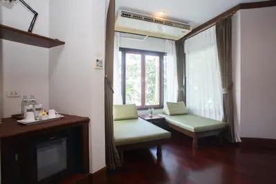 a living room with a couch and a window at Golden Beach Resort in Ao Nang Beach