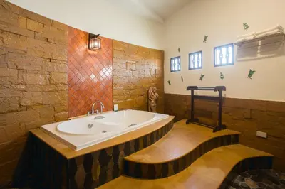 a bathroom with a large tub in a room at Golden Beach Resort in Ao Nang Beach