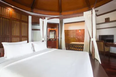 a bedroom with a white bed and a desk at Golden Beach Resort in Ao Nang Beach