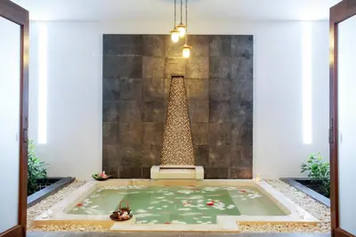 a large bath tub in a room with a fountain at Andamantra Resort and Villa Phuket in Patong Beach