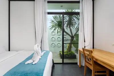 a bedroom with a bed and a desk and a window at MONO LUX Villa x MonthStayZ Thailand in Chalong