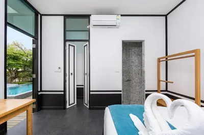 a bedroom with a bed and a pool at MONO LUX Villa x MonthStayZ Thailand in Chalong
