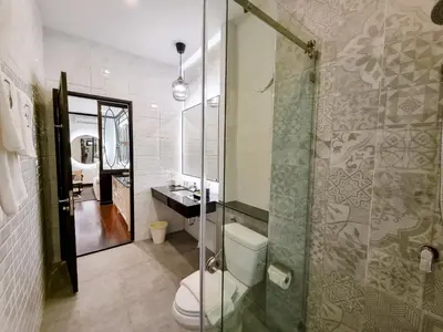 a bathroom with a toilet and a glass shower at BAAN 125 STAY Phuket in Phuket Town