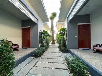 a hallway with a palm tree in a building at Purepamvillage in Kata Beach