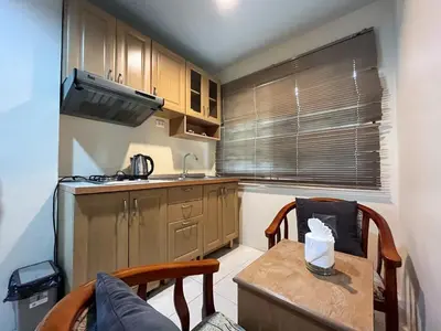 a small kitchen with a table and a sink at Purepamvillage in Kata Beach