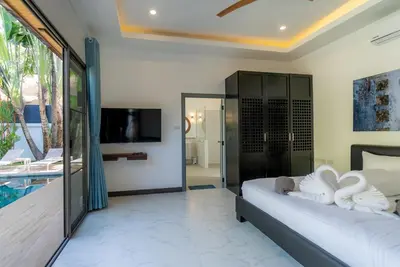 a bedroom with a bed with white towels on it at villa Akala in Ban Saiyuan (1)