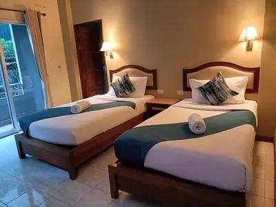 a hotel room with two beds and a window at Lalisa Hotel Aonang in Ao Nang Beach
