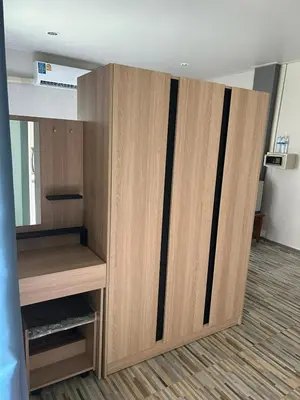 a large wooden cabinet in an empty room at Lalisa Hotel Aonang in Ao Nang Beach