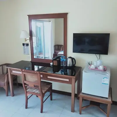 a room with a desk with a mirror and a television at Lalisa Hotel Aonang in Ao Nang Beach