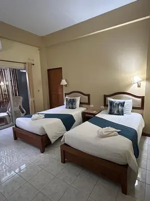a hotel room with two beds and a window at Lalisa Hotel Aonang in Ao Nang Beach
