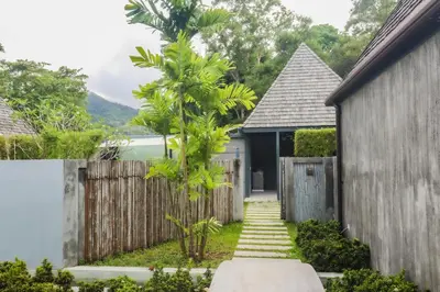 a house with a gate and a fence at Tao Resort and Villas (SHA Extra+) in Phuket Town