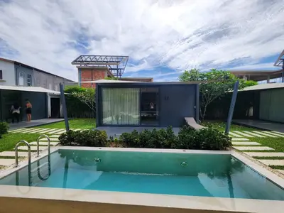 a house with a swimming pool in the yard at Tao Resort and Villas (SHA Extra+) in Phuket Town