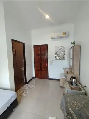 a hotel room with a bed and a bathroom at Passion Nai Harn Guesthouse in Nai Harn Beach