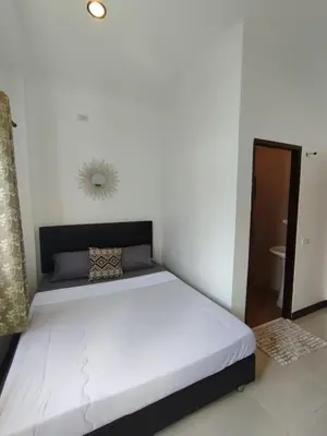 a bedroom with a large white bed in a room at Passion Nai Harn Guesthouse in Nai Harn Beach