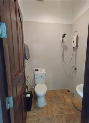 a bathroom with a toilet and a shower at Passion Nai Harn Guesthouse in Nai Harn Beach