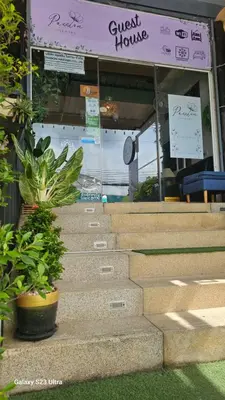 a set of stairs with plants in front of a house at Passion Nai Harn Guesthouse in Nai Harn Beach