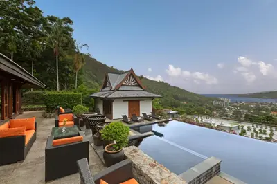 a resort with a swimming pool and a house at Nakawanna Villa in Phuket Town