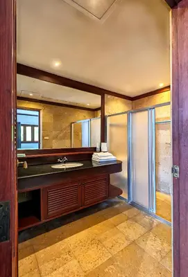 a bathroom with a sink and a mirror at Nakawanna Villa in Phuket Town