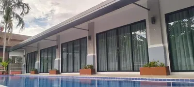 a building with a swimming pool in front of it at De palm poolvilla by KC in Ban Chin Tham Mai