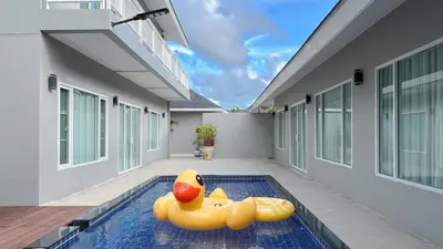 a yellow rubber duck is sitting in a swimming pool at De palm poolvilla by KC in Ban Chin Tham Mai