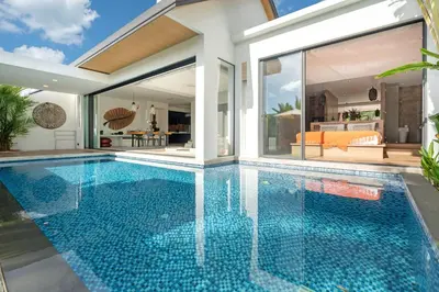 a swimming pool in a villa with a house at Sunny Day Dream Villa - Nai Yang Beach in Thalang