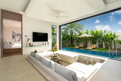 an open living room with a large window and a swimming pool at Sunny Day Dream Villa - Nai Yang Beach in Thalang