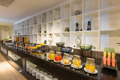 a counter with many different types of drinks in jars at The Charm Resort Phuket in Patong Beach