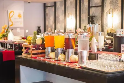 a bar with glasses of juice and drinks at The Charm Resort Phuket in Patong Beach