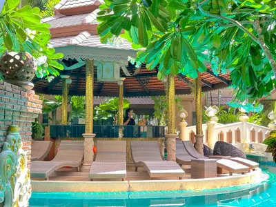 a resort with a bar in the middle of a pool at Quality Beach Resorts and Spa Patong in Patong Beach