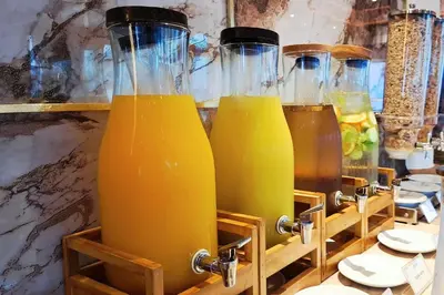 a row of bottles of orange juice on a shelf at Quality Beach Resorts and Spa Patong in Patong Beach