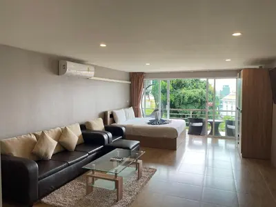 a living room with a couch and a bed at Private apartment at Bayshore by Lofty in Patong Beach