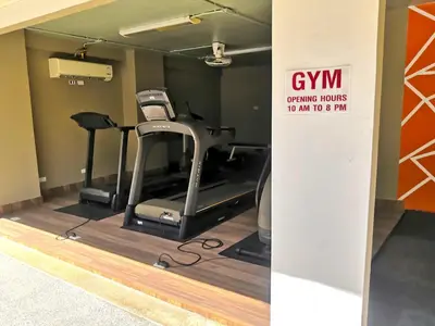 a gym with a treadmill and a exercise bike at Private apartment at Bayshore by Lofty in Patong Beach