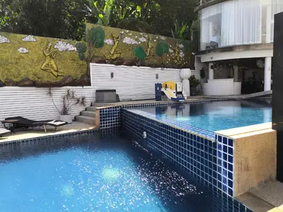 a swimming pool with blue tiles on the side of a building at Private apartment at Bayshore by Lofty in Patong Beach