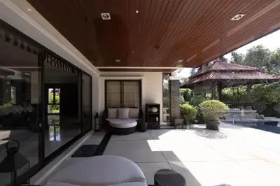 an outdoor patio with a tub and a pool at Laguna Links Golf View Villa- Bangtao Beach in Phuket Town