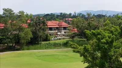 a golf course with a house in the background at Laguna Links Golf View Villa- Bangtao Beach in Phuket Town