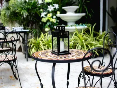a table and chairs in a patio with a fountain at Anchor Boutique House in Patong Beach