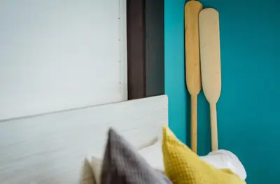a counter with two wooden knives and pillows next to a window at Anchor Boutique House in Patong Beach