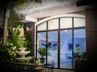 a room with a large glass door with plants at Anchor Boutique House in Patong Beach