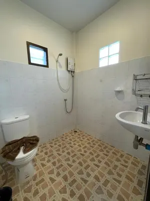 a bathroom with a toilet and a sink at Ron Bungalow in Bang Tao Beach