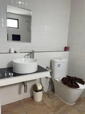 a bathroom with a sink and a toilet and a mirror at Ron Bungalow in Bang Tao Beach