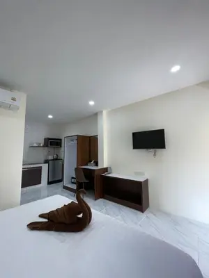 a room with a bed with a wooden snake on it at Ron Bungalow in Bang Tao Beach