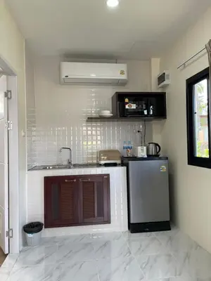 a kitchen with a stove and a refrigerator at Ron Bungalow in Bang Tao Beach