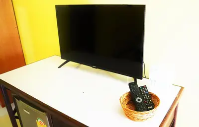 a flat screen tv sitting on a table with a remote control at Koh Yao Noi Beach Resort in Ko Yao Noi