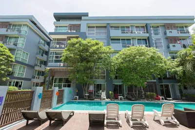 a swimming pool in front of a building at Kris - Modern Spacious 2 Bedrooms Condo with Pool in Patong Beach