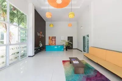 a living room with a couch and a table at Kris - Modern Spacious 2 Bedrooms Condo with Pool in Patong Beach